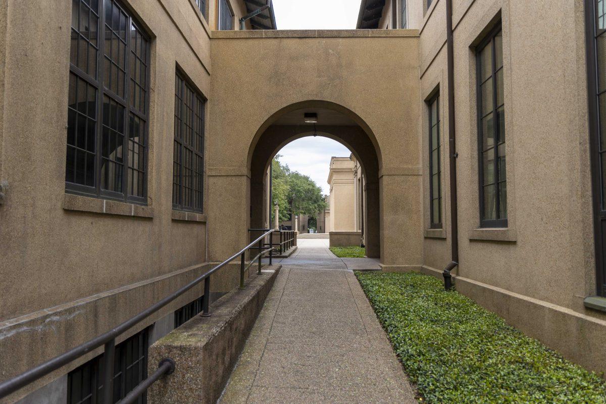 A corridor leading to Memorial Tower frames a view Monday, April 24, 2023, on LSU's campus.