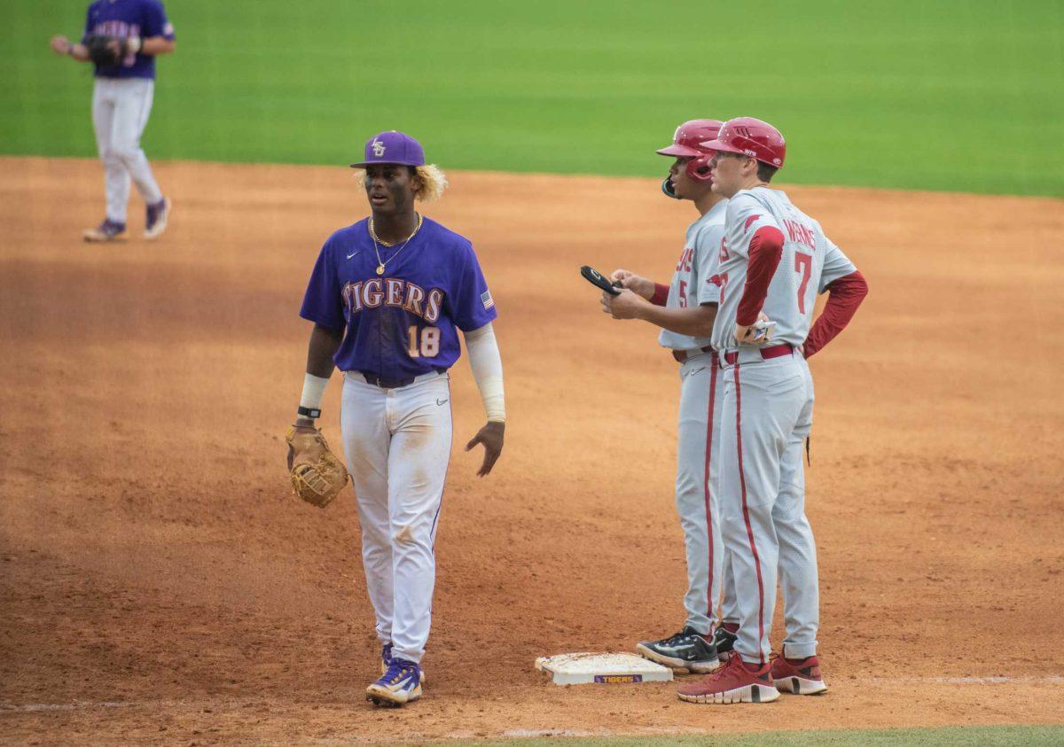 LSU baseball junior first baseman Tre' Morgan (18) stands at first base on Friday, March 24, 2023, during LSU's 3-9 loss against Arkansas in Alex Box Stadium in Baton Rouge, La.