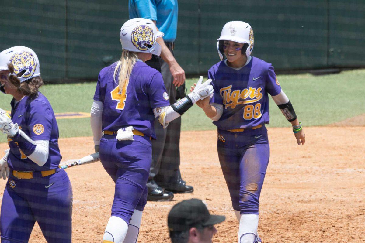 LSU softball junior outfielder Ciara Briggs (88) high fives sophomore outfielder McKenzie Redoutey (4) Saturday, May 20, 2023, during LSU&#8217;s 4-0 win against ULL at Tiger Park in Baton Rouge, La.