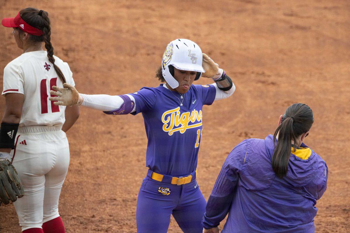 <p>LSU softball junior infielder Danieca Coffey (13) dances after reaching first base Saturday, May 20, 2023, during LSU’s 4-0 win against ULL at Tiger Park in Baton Rouge, La.</p>