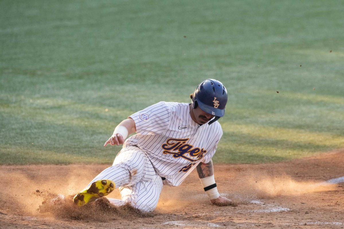 LSU baseball redshirt junior catcher Hayden Travinski (25) slides into home base Tuesday, May 16, 2023, during LSU&#8217;s 7-4 win against McNeese Statue University at Alex Box Stadium in Baton Rouge, La.