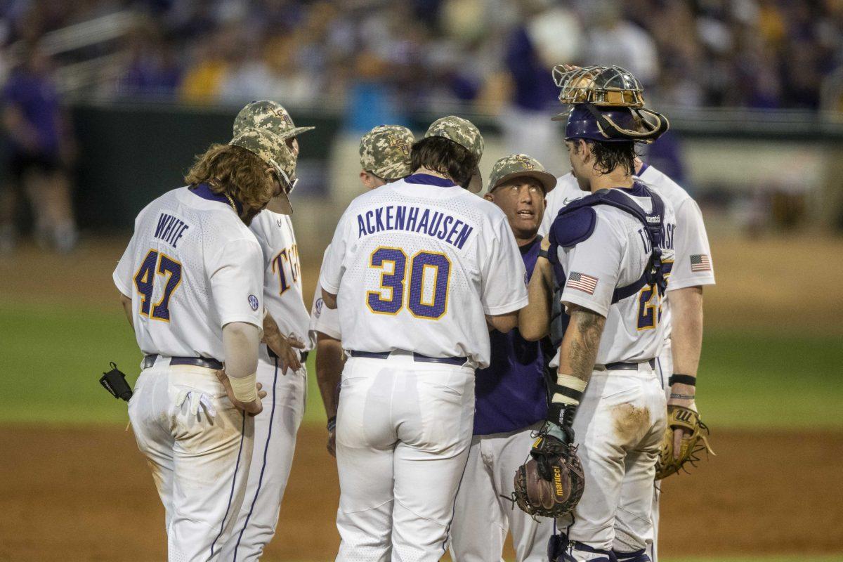 LSU baseball players huddle up around head coach Jay Johnson Saturday, May 13, 2023, during LSU's 9-4 lost to Mississippi State at Alex Box Stadium in Baton Rouge, La.