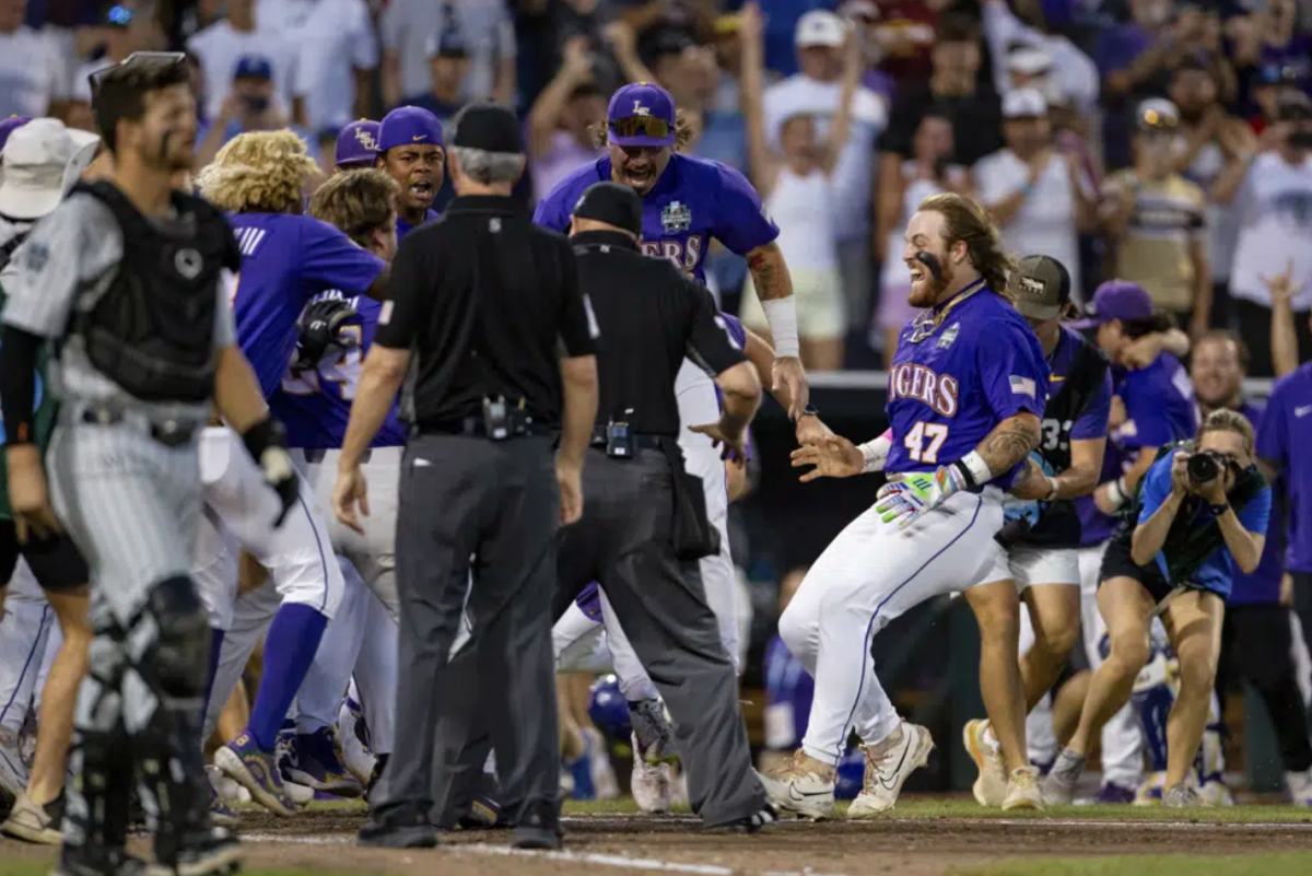 LSU's Tommy White (47) is greeted at the plate after his game-winning home run against Wake Forest during the 11th inning of a baseball game at the NCAA College World Series in Omaha, Neb., Thursday, June 22, 2023. (AP Photo/John Peterson)