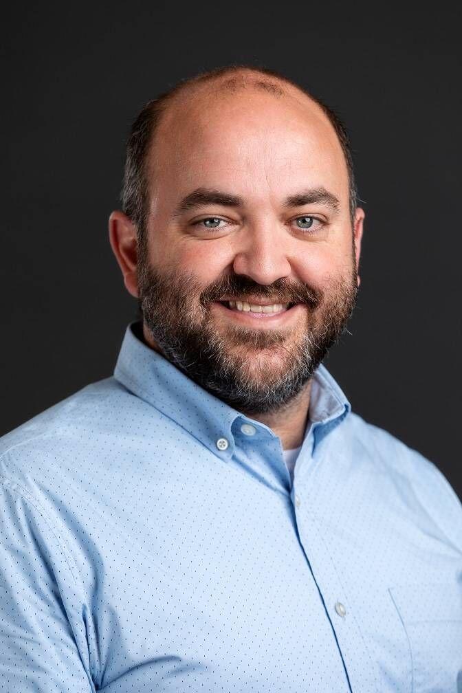 Josh Grimm, interim dean of the Manship School of Mass Communication, smiles in a photo.