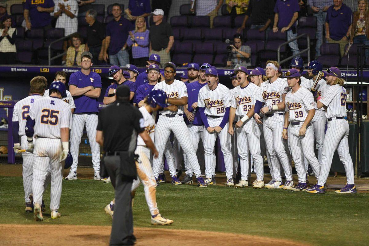 The LSU baseball team celebrates after graduate student Cade Beloso (24) hits a home run on Tuesday, April 25, 2023, during LSU&#8217;s 6-5 loss to Nicholls at Alex Box Stadium in Baton Rouge, La.