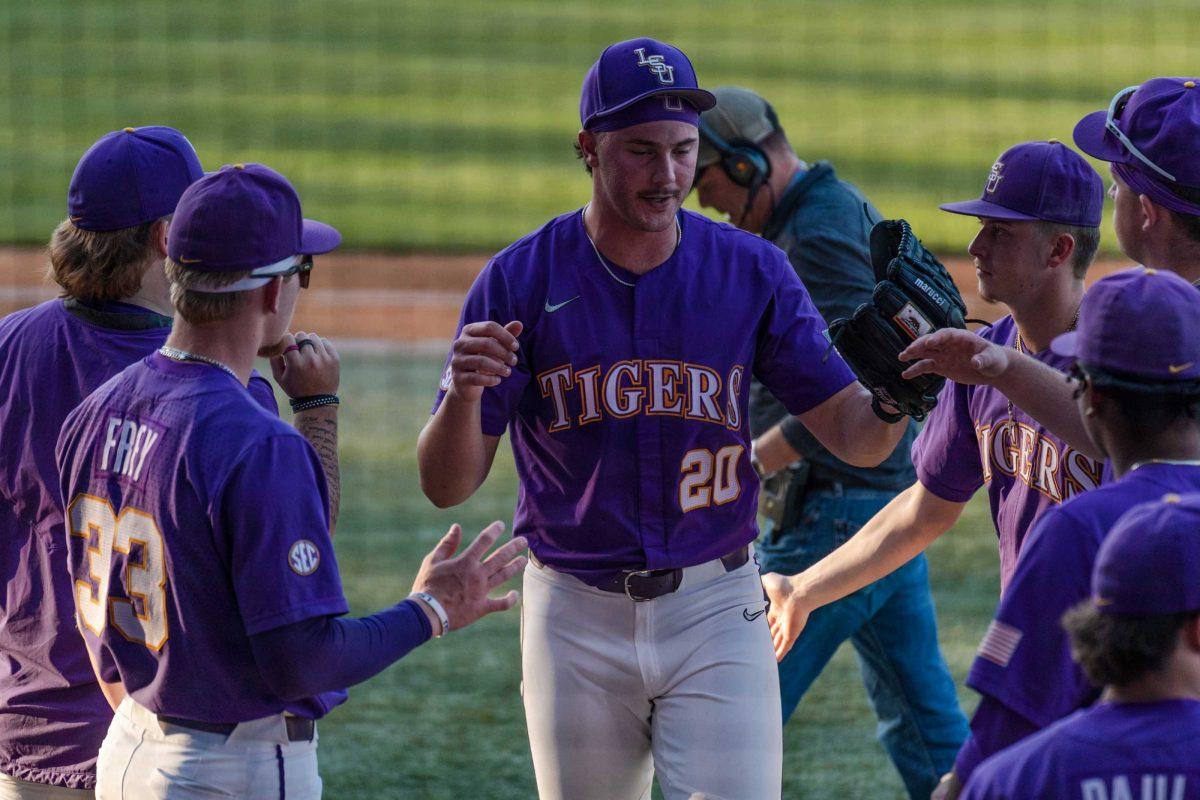 The LSU baseball team high-fives junior pitcher Paul Skenes (20) as he returns to the dugout on Friday, April 28, 2023, during LSU&#8217;s 8-6 win over Alabama at Alex Box Stadium in Baton Rouge, La.