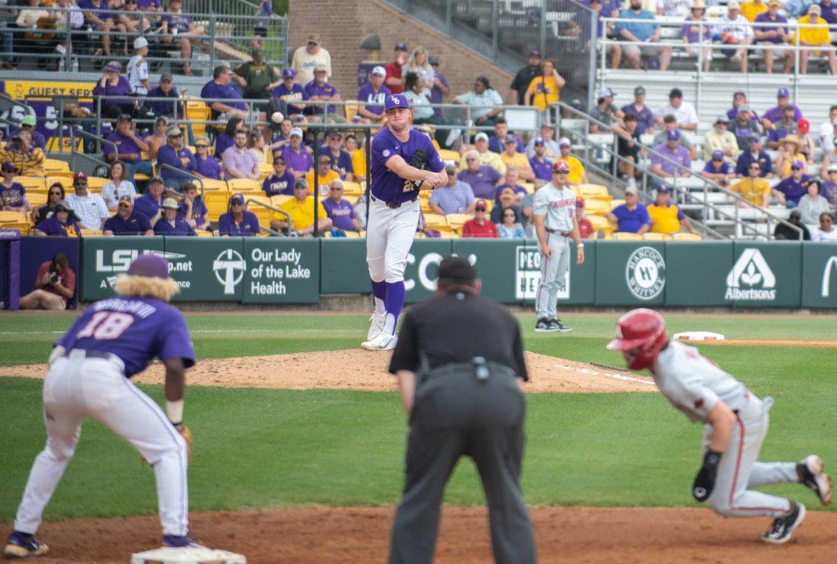 LSU baseball junior right-handed pitcher Paul Skenes (20) attempts to pick off a base runner on Friday, March 24, 2023, during LSU's 3-9 loss against Arkansas in Alex Box Stadium in Baton Rouge, La.