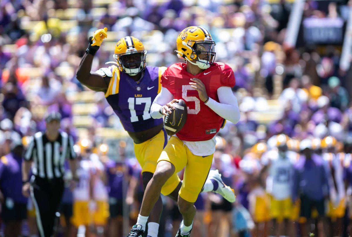 LSU football senior quarterback Jayden Daniels (5) avoids the defense on Saturday, April 22, 2023, during LSU&#8217;s 32-32 tie during the spring game in Tiger Stadium in Baton Rouge, La.