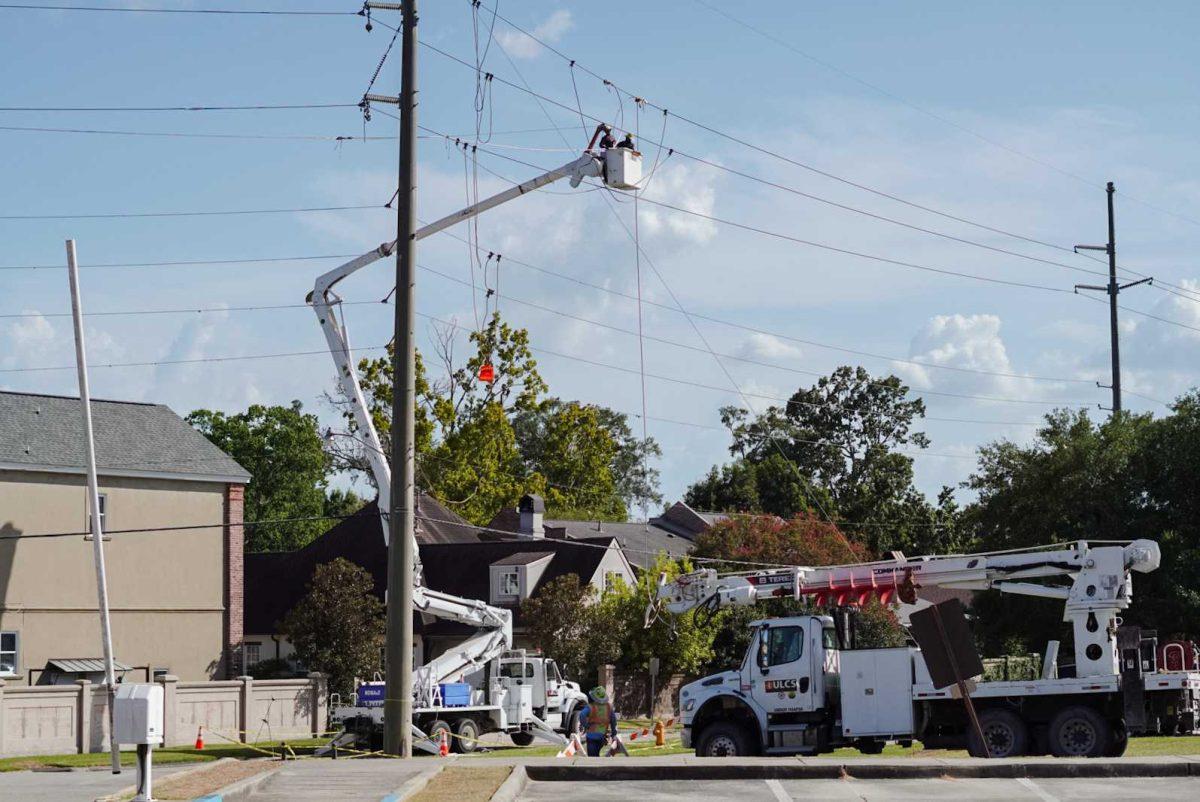 An electric crew works on power lines on Tuesday, Aug. 22, 2023, on East Parker Blvd. near LSU&#8217;s campus in Baton Rouge, La.