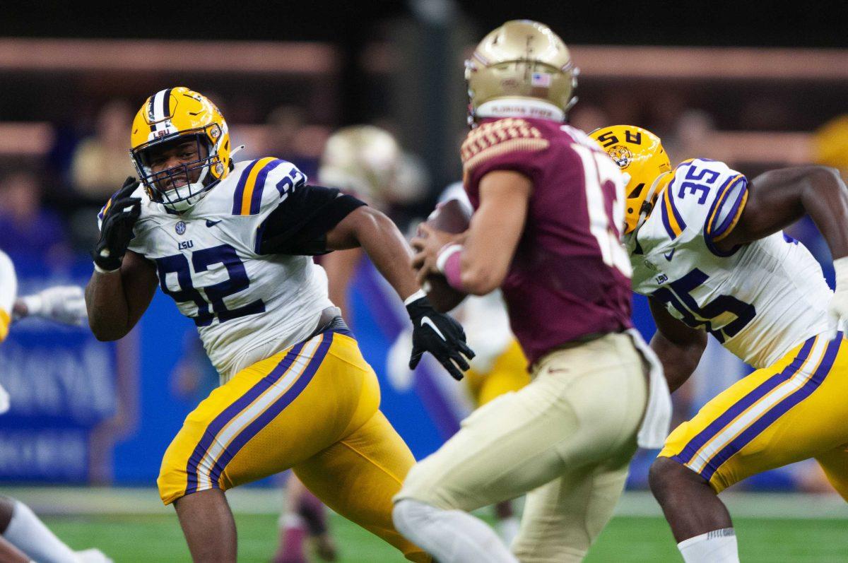 LSU football sophomore defensive lineman Mekhi Wingo (92) eyes down Florida State redshirt junior quarterback Jordan Travis (13) Sunday, Sept. 4, 2022, during LSU's Allstate Kickoff game defeat to Florida State 23-24 in the Caesars Superdome, New Orleans, La.