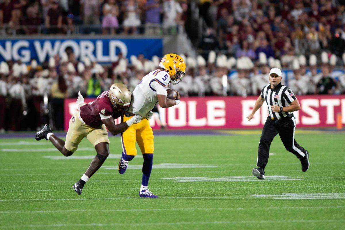 <p>LSU football senior quarterback Jayden Daniels (5) gets tackled by Florida State redshirt senior linebacker (4) on Sunday, Sept. 3, 2023, during LSU’s 45-24 loss to Florida State at Camping World Stadium in Orlando, Fl.</p>