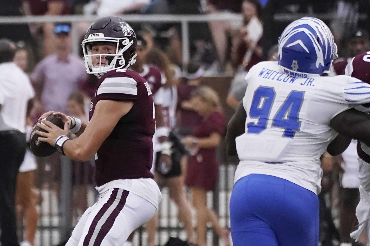 Mississippi State quarterback Will Rogers (2) passes under pressure from Memphis defensive lineman William Whitlow Jr. (94) during the first half of an NCAA college football game in Starkville, Miss., Saturday, Sept. 3, 2022. (AP Photo/Rogelio V. Solis)