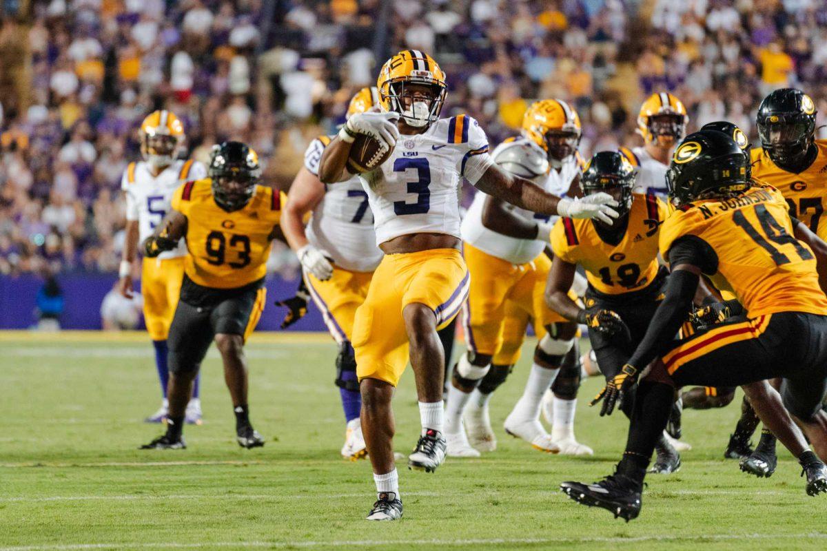 LSU football junior running back Logan Diggs (3) attempts to leap over a defender on Saturday, Sept. 9, 2023, during LSU&#8217;s 72-10 win against Grambling State in Tiger Stadium in Baton Rouge, La.