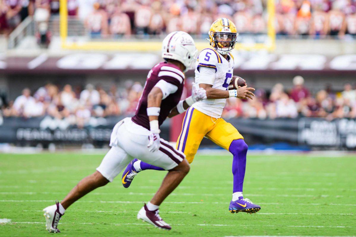 LSU football senior quarterback Jayden Daniels (5) looks past his defender on Saturday, Sept. 16, 2023, during LSU's 41-14 win over Mississippi State in Davis Wade Stadium in Starkville, MS.