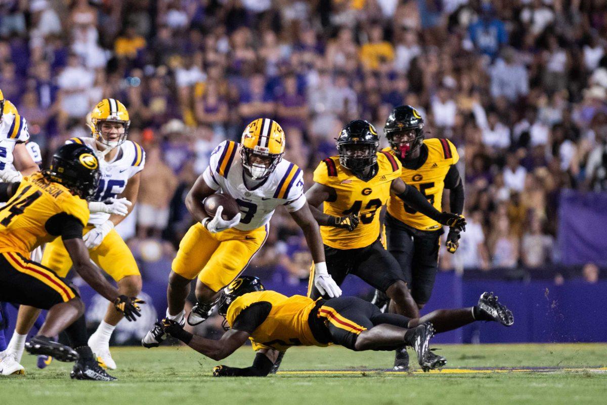 LSU football junior running back Logan Diggs (3) avoids a tackle on Saturday, Sept. 9, 2023, during LSU&#8217;s 72-10 win over Grambling State at Tiger Stadium in Baton Rouge, La.