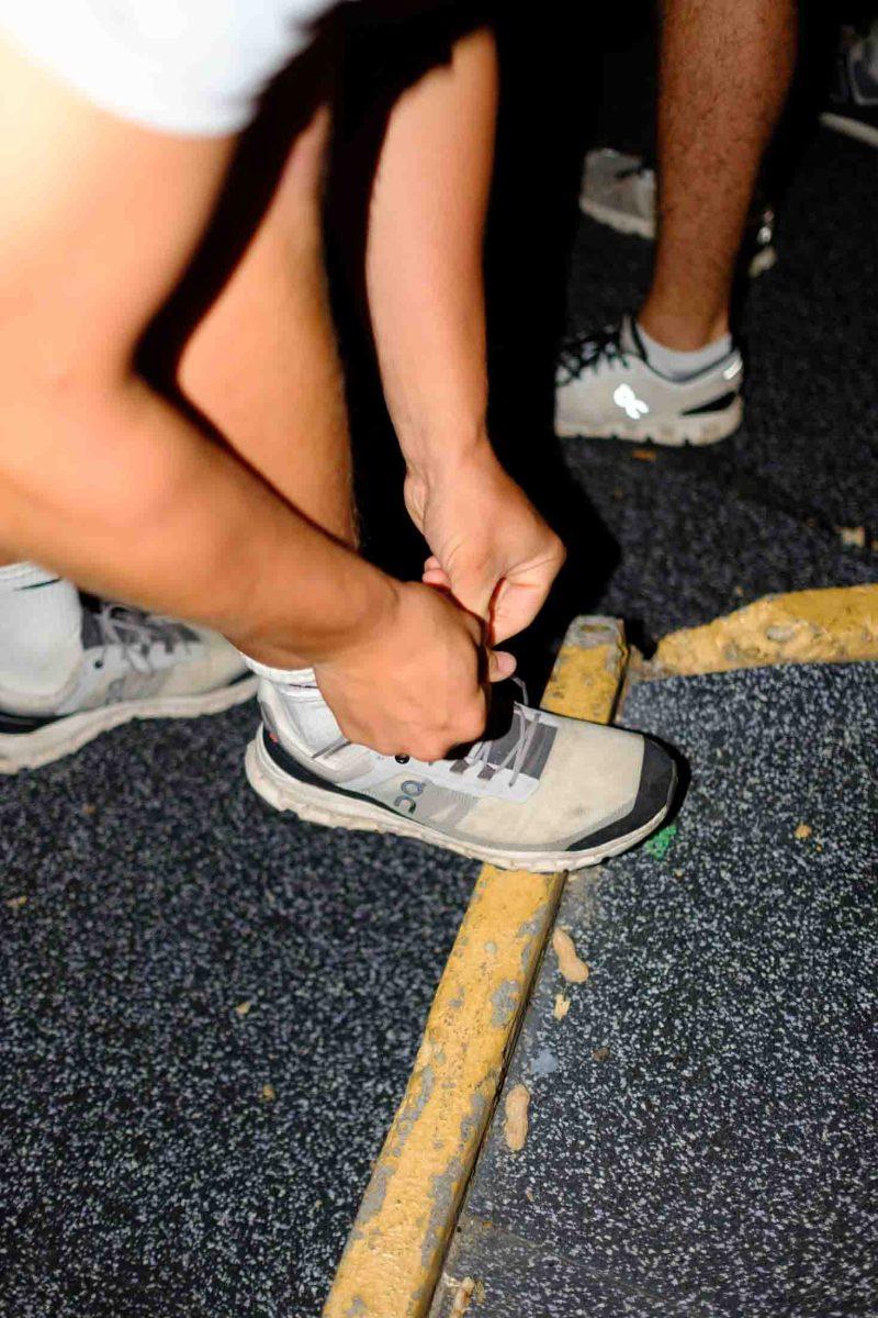 A student ties his shoe, getting ready for the 9/11 memorial stair climb in Tiger Stadium, Sept. 11, 2023.