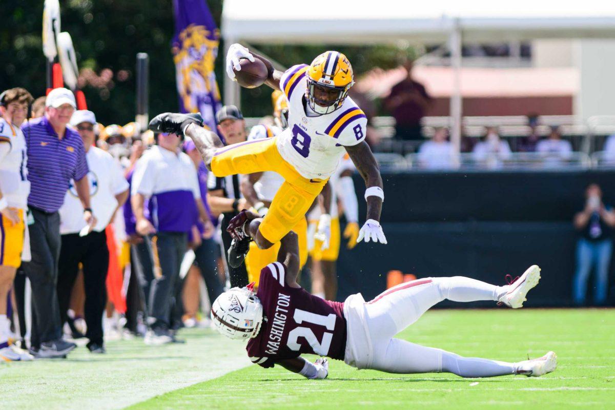 LSU football junior wide receiver Malik Nabers (8) flies over his defender on Saturday, Sept. 16, 2023, during LSU's 41-14 win over Mississippi State in Davis Wade Stadium in Starkville, MS.