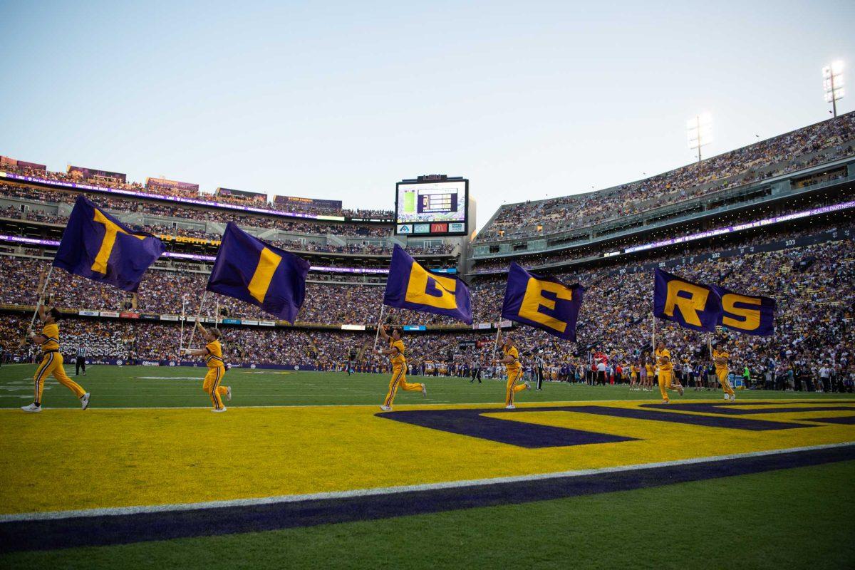 The LSU cheerleaders run through the endzone with flags after a touchdown on Saturday, Sept. 9, 2023, during LSU football&#8217;s 72-10 win over Grambling State at Tiger Stadium in Baton Rouge, La.