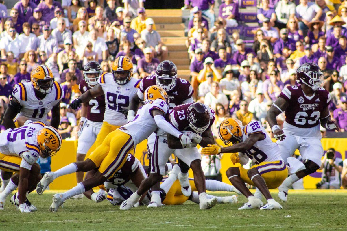 <p>LSU football senior safety Jay Ward (5) and sophomore safety Major Burns (28) tackle Mississippi State football junior running back Dillon Johnson (23) Saturday, Sept. 17, 2022 during LSU’s 31-16 win against Mississippi State at Tiger Stadium in Baton Rouge, La.</p>