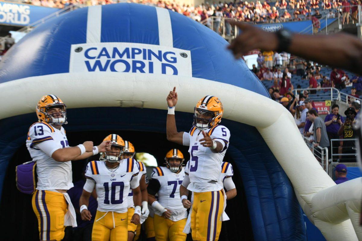 LSU football senior quarterback Jayden Daniels (5) runs onto the field before the start of the game on Sunday, Sept. 3, 2023, against Florida State at Camping World Stadium in Orlando, Fl.