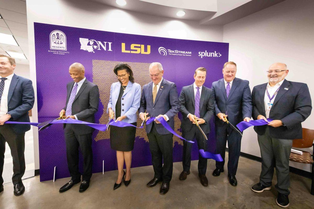 LSU President William Tate IV, Louisiana Gov. John Bel Edwards and others cut the ribbon at the opening of the LSU and LONI Security Operations Center.