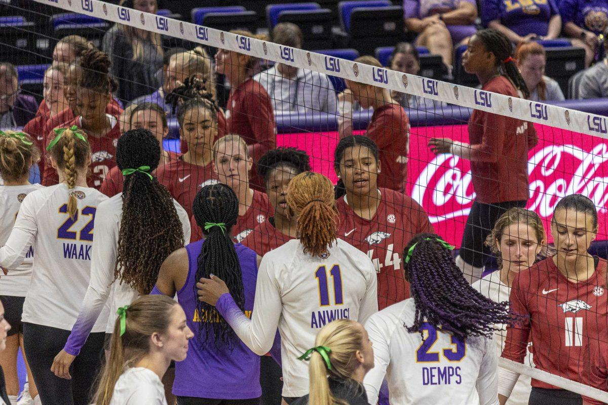 The LSU volleyball shakes hands with the Arkansas team Wednesday, Oct. 4, 2023, following LSU's 3-0 loss to Arkansas at the Pete Maravich Assembly Center in Baton Rouge, La.