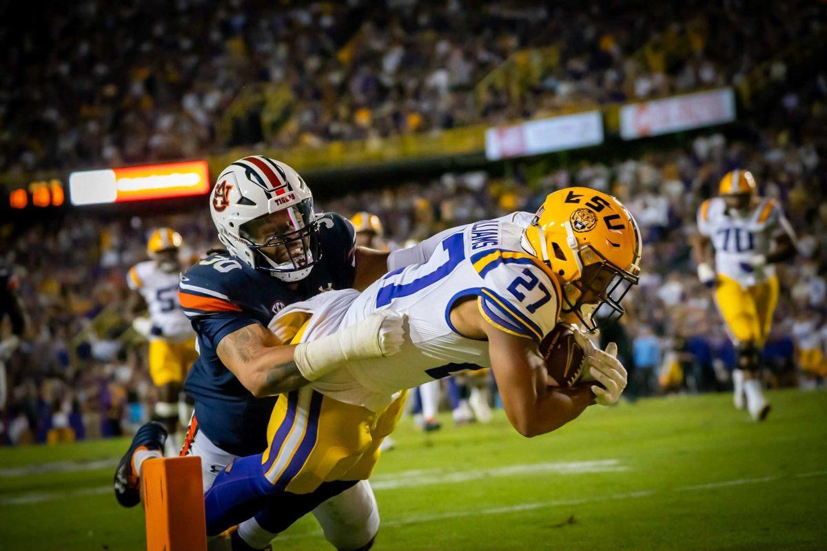 <p>LSU football graduate student running back Josh Williams (27) jumps for the touchdown during the 48-18 LSU win vs. Auburn on Saturday, Oct. 14, 2023, at Tiger Stadium in Baton Rouge, La.</p>