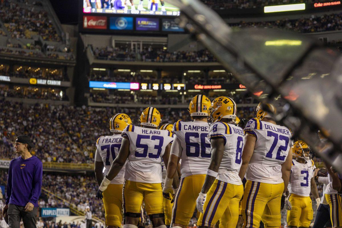 LSU football plays huddle up during a timeout Saturday, Oct. 14, 2023, during LSU&#8217;s 48-18 win against Auburn in Tiger Stadium in Baton Rouge, La.