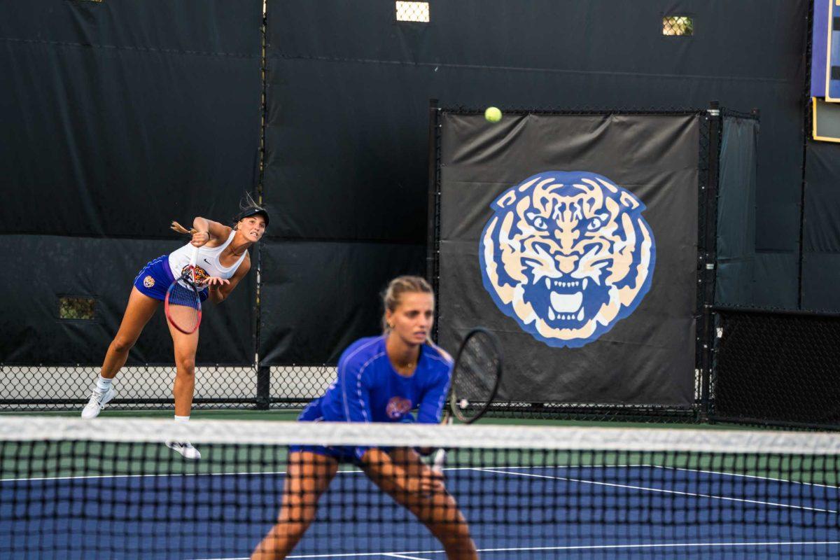 <p>LSU women's tennis graduate student Aran Texido-Garcia serves with junior Florentine Dekkers ready at the net during their 8-1 doubles win against Louisiana Tech during the round of 64 of the regional ITAs Friday, Oct. 6, 2023, at the LSU tennis complex on Gourrier Drive in Baton Rouge, La.</p>