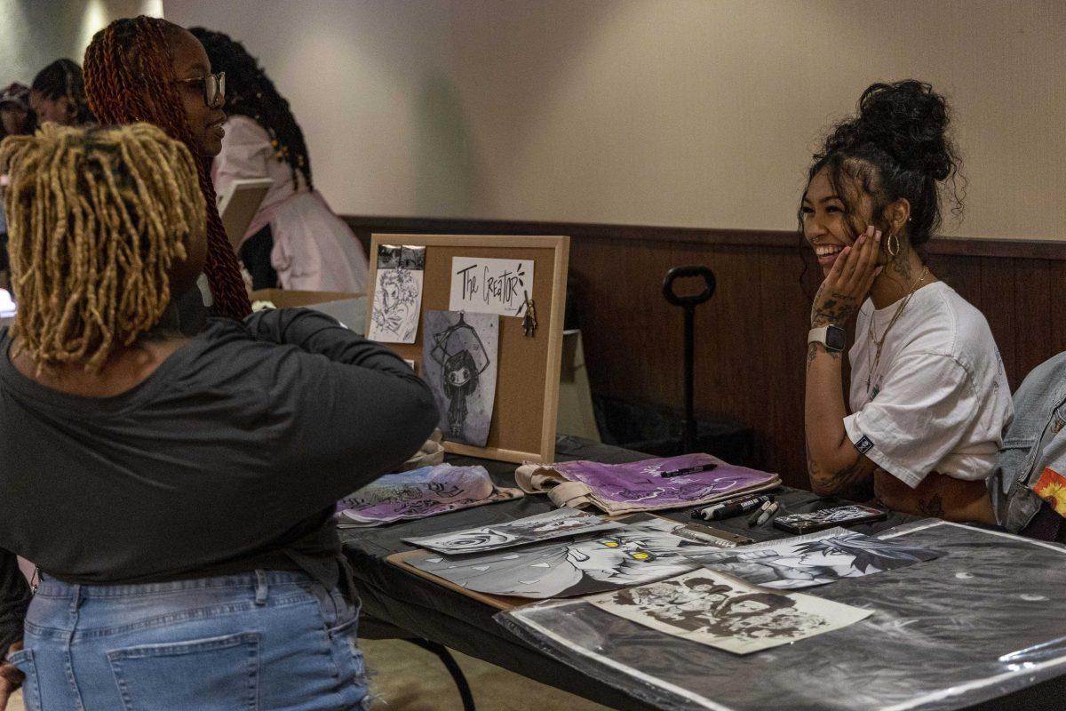 An artist smiles while talking about her work Wednesday, Oct. 18, 2023, during a Black business pop up shop sale in the Magnolia room in the LSU Student Union.