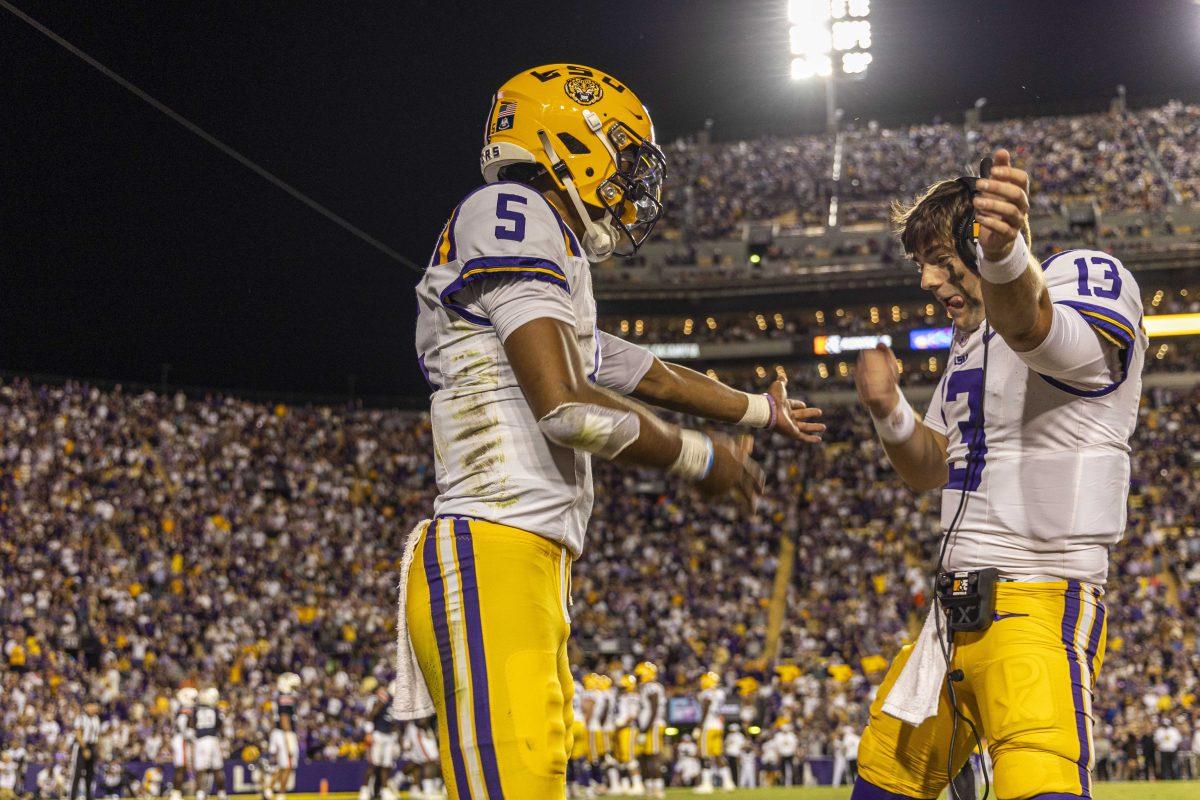 LSU football senior quarterback Jayden Daniels (9) celebrates a touchdown with sophomore quarterback Garrett Nussmeier (13) Saturday, Oct. 14, 2023, during LSU&#8217;s 48-18 win against Auburn in Tiger Stadium in Baton Rouge, La.