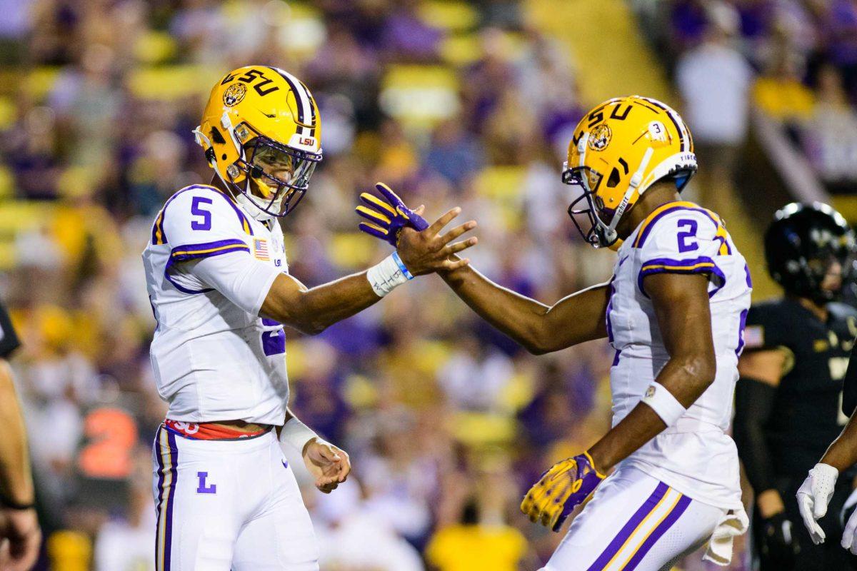 LSU football senior quarterback Jayden Daniels (5) celebrates a touchdown with LSU football senior wide receiver Kyren Lacy (2) on Saturday, Oct. 21, 2023, during LSU's 62-0 victory against Army in Tiger Stadium in Baton Rouge, La.