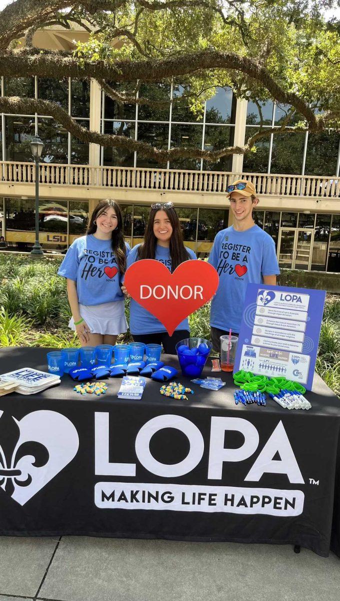 Members Brianna Wesselhoff, Macy Schmelz and Anthony Chiasson with LOPA in Free Speech Alley