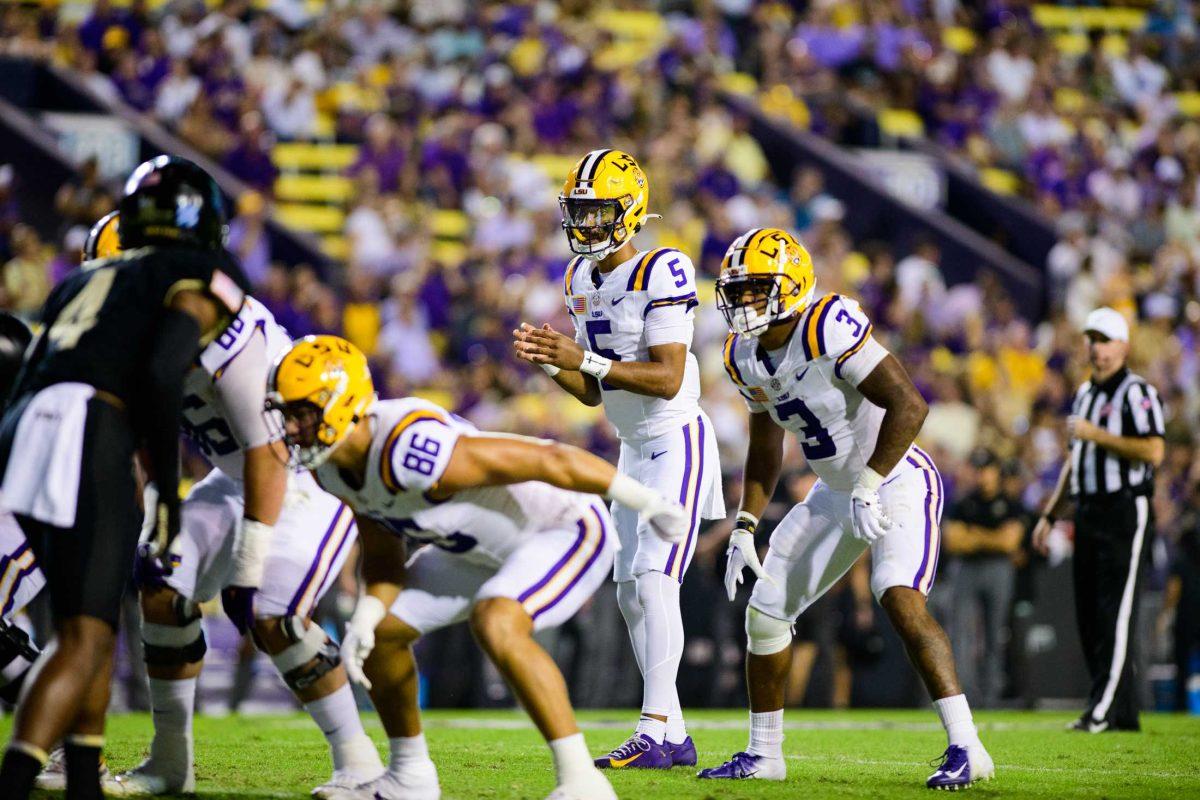 LSU football senior quarterback Jayden Daniels (5) gets into formation on Saturday, Oct. 21, 2023, during LSU's 62-0 victory against Army in Tiger Stadium in Baton Rouge, La.