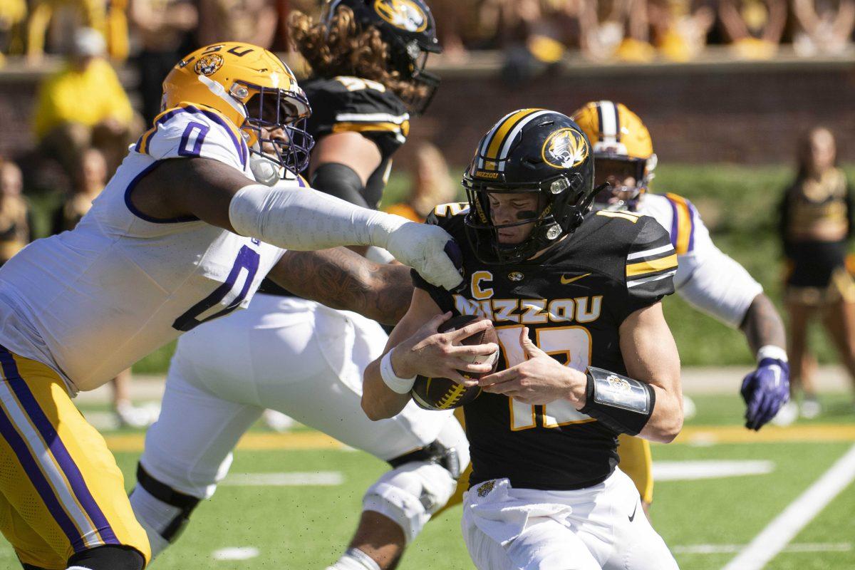 Missouri quarterback Brady Cook, right, is sacked by LSU defensive tackle Maason Smith, left, during the fourth quarter of an NCAA college football game Saturday, Oct. 7, 2023, in Columbia, Mo. LSU won 49-39. (AP Photo/L.G. Patterson)