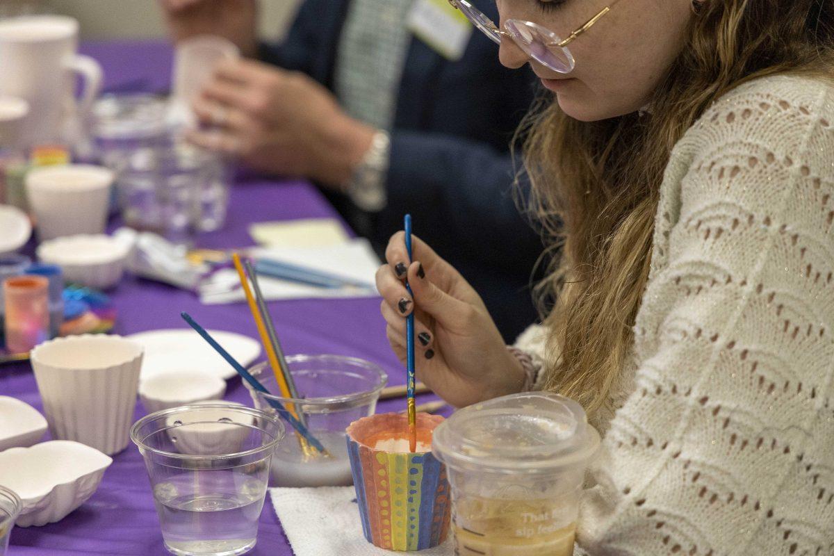 An event goer paints a pot Wednesday, Oct. 11, 2023, during the Pride Pots event at the Women's Center on 110 Veterans Dr.