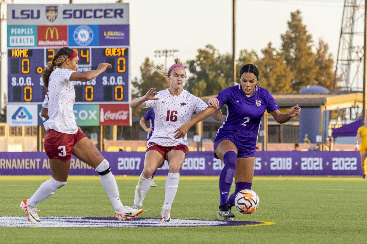 LSU soccer sophomore defender Jocelyn Ollivierre (2) fights for control over the ball against Arkansas defenders Thursday, Oct. 19, 2023, during LSU's 1-1 draw against Arkansas at the LSU Soccer Stadium.