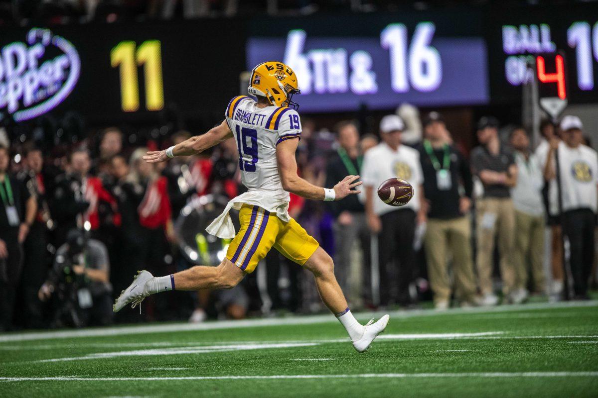 LSU football senior punter Jay Bramblett (19) kicks a punt Saturday, Dec. 3, 2022, during LSU's 30-50 defeat to Georgia at the Southeastern Conference Championship at the Mercedes-Benz Stadium in Atlanta, Georgia.