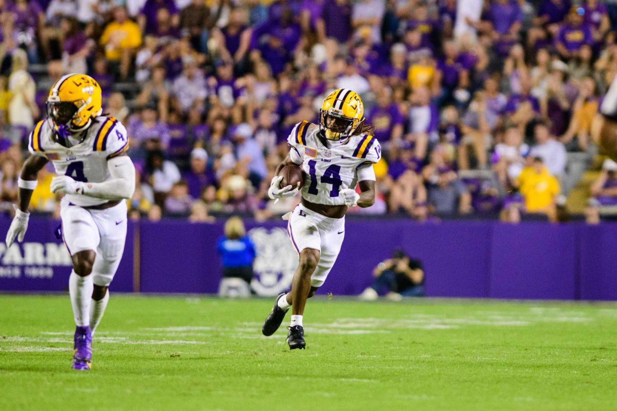 LSU football senior safety Andre' Sam (14) sprints downfield after an interception on Saturday, Oct. 21, 2023, during LSU's 62-0 victory against Army in Tiger Stadium in Baton Rouge, La.