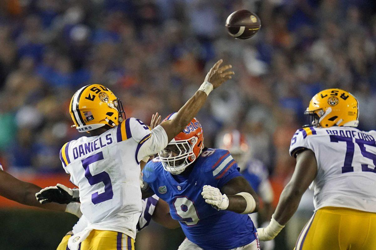 Florida defensive lineman Gervon Dexter Sr. (9) bears down on LSU quarterback Jayden Daniels (5) during the second half of an NCAA college football game, Saturday, Oct. 15, 2022, in Gainesville, Fla. Dexter was penalized for a late hit. (AP Photo/John Raoux)