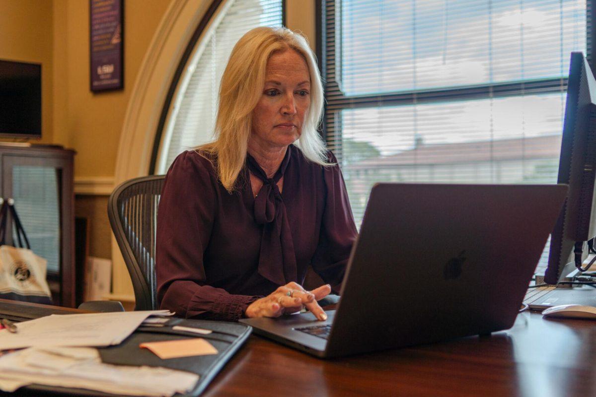 Manship School Dean Kimberly Bissell works on her laptop on Wednesday, Nov. 8, 2023, inside her office in the Journalism Building on LSU's campus.