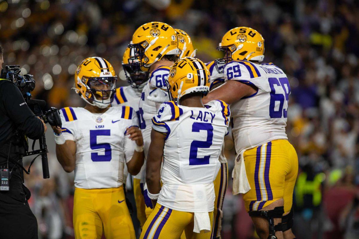 LSU football senior quarterback Jayden Daniels (5) and LSU football senior wide receiver Kyren Lacy (2) and their teammates celebrate a touchdown on Saturday, Nov. 4, 2023, during LSU's 42-28 loss against Alabama in Bryant-Denny stadium in Tuscaloosa, Al.