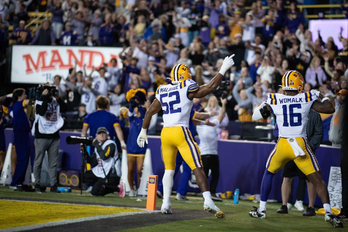 LSU football sophomore linebacker Princeton Malbrue (52) and freshman defensive end Da'Shawn Womack (16) hype up the crowd Saturday, Nov. 11, 2023, during LSU&#8217;s 52-35 win against Florida at Tiger Stadium in Baton Rouge, La.