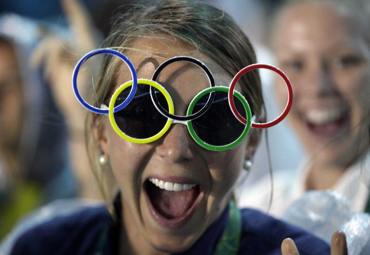 Jackie Briggs from the United States wears the Olympic ring sunglasses during the closing ceremony in the Maracana stadium at the 2016 Summer Olympics in Rio de Janeiro, Brazil, Sunday, Aug. 21, 2016.