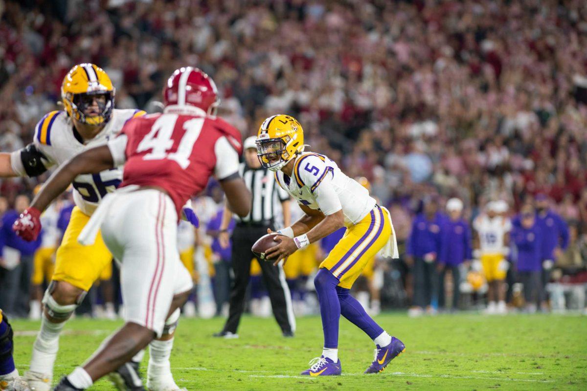 LSU football senior quarterback Jayden Daniels (5) gets ready to run with the ball on Saturday, Nov. 5, 2023, during LSU's 42-28 loss against Bama in Bryant-Denny stadium in Tuscaloosa, Al.