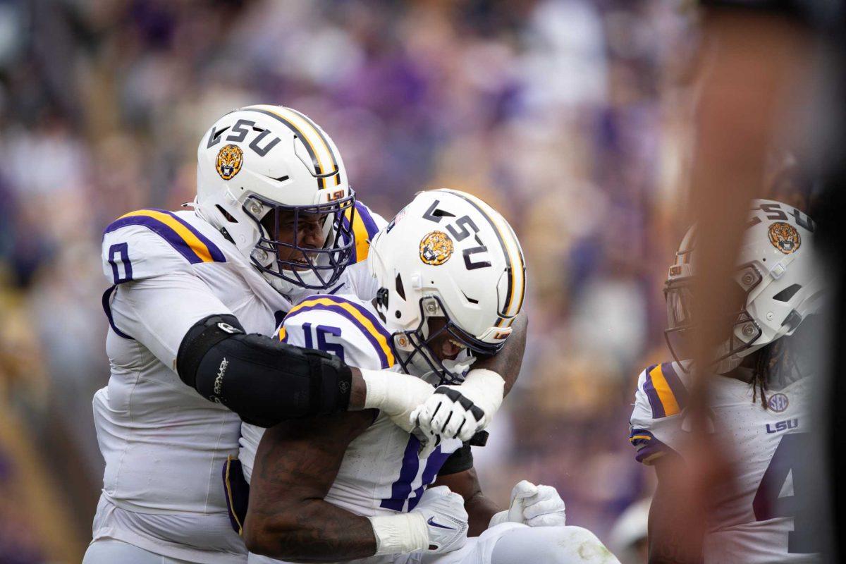 LSU football redshirt sophomore defensive tackle Maason Smith (0) hugs freshman defensive end Da'Shawn Womack (16) Saturday, Nov. 25, 2023, during LSU's 42-30 win against Texas A&amp;M at Tiger Stadium in Baton Rouge, La.