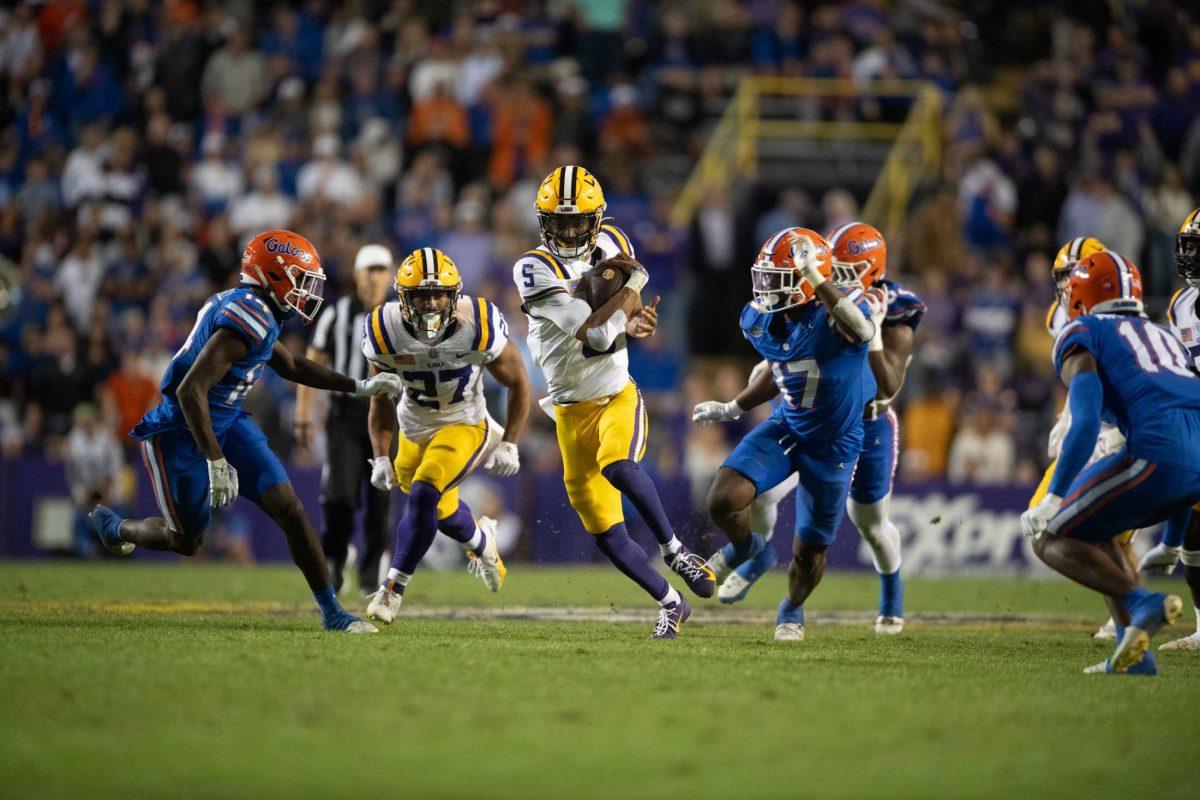 <p>LSU football senior quarterback Jayden Daniels (5) runs the ball Saturday, Nov. 11, 2023, during LSU’s 52-35 win against Florida at Tiger Stadium in Baton Rouge, La.</p>