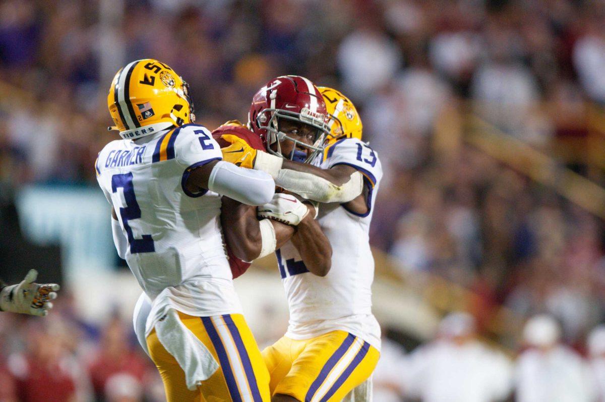 LSU football cornerback Mekhi Garner (2) and safety Joe Foucha (13) tackle an Alabama player on Saturday, Nov. 5, 2022, during LSU&#8217;s 32-31 victory over Alabama in Tiger Stadium in Baton Rouge, La.