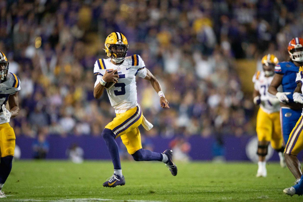 LSU football senior quarterback Jayden Daniels (5) runs with the ball Saturday, Nov. 11, 2023, during LSU&#8217;s 52-35 win against Florida at Tiger Stadium in Baton Rouge, La.