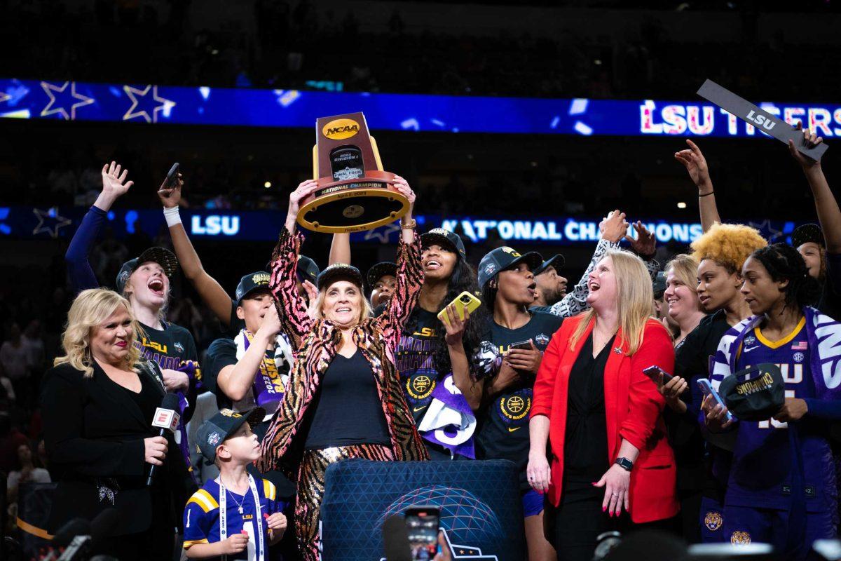 LSU women&#8217;s basketball head coach Kim Mulkey lifts their trophy into the air on Sunday, April 2, 2023, after LSU's 102-85 win against Iowa in the NCAA National Championship in the American Airlines Center in Dallas, Texas.